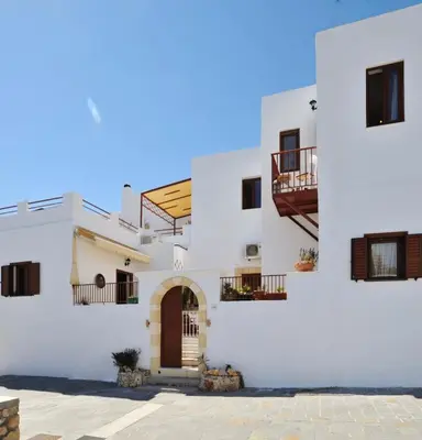a white building with a door and balconies at Nikelen Lindian Exclusive Apartments in Líndos
