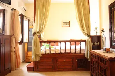 a bedroom with a crib in a room with curtains at Nikelen Lindian Exclusive Apartments in Líndos