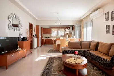 a living room with a couch and a tv at Savvinas House Faliraki-Traganou Beach in Faliraki