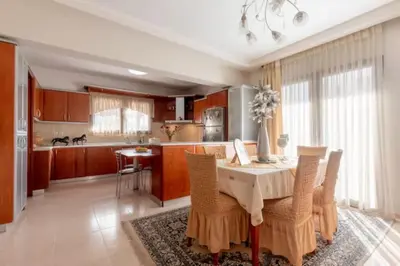 a kitchen with a table and chairs in a room at Savvinas House Faliraki-Traganou Beach in Faliraki