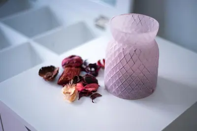 a purple vase sitting on top of a counter with some fruit at TownHall Apartment's in Rhodes Town