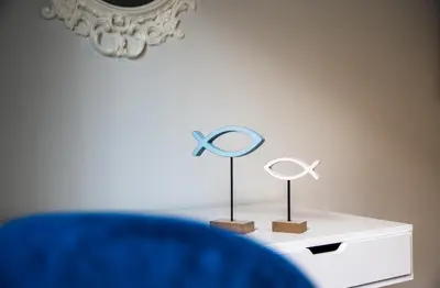 a table with a mirror and two figurines on it at TownHall Apartment's in Rhodes Town