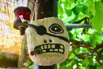 a stuffed animal is attached to a pole at Nitsa's Apartments in Megálon Choríon