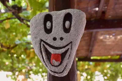 a puppet of a face on a wooden pole at Nitsa's Apartments in Megálon Choríon