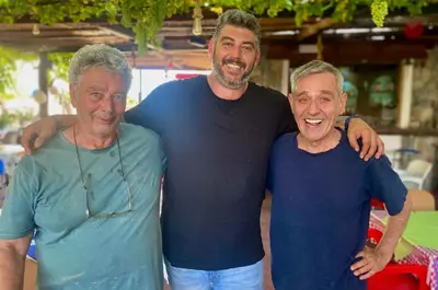 three men standing next to each other posing for a picture at Nitsa's Apartments in Megálon Choríon