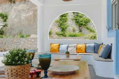 a living room with a couch and a table at Anatoli Traditional Villa in Archangelos