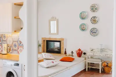 a living room with a bed and a fireplace at Anatoli Traditional Villa in Archangelos