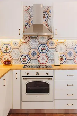 a kitchen with white cabinets and a white oven at Anatoli Traditional Villa in Archangelos