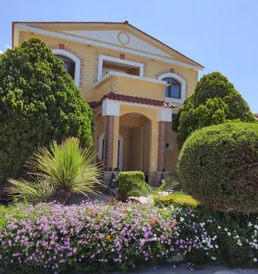 a house with flowers in front of it at Nicole Luxury Villas in Koskinou