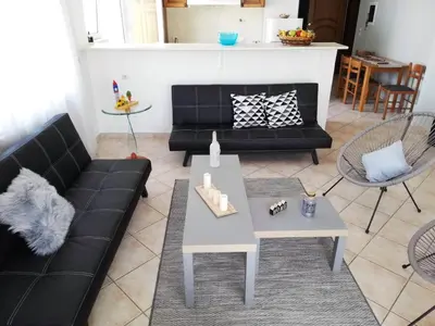 a living room with a black couch and a table at Casa Dama in Rhodes Town