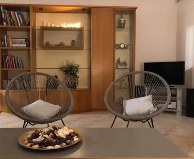 two chairs sitting in a living room with a table at Casa Dama in Rhodes Town
