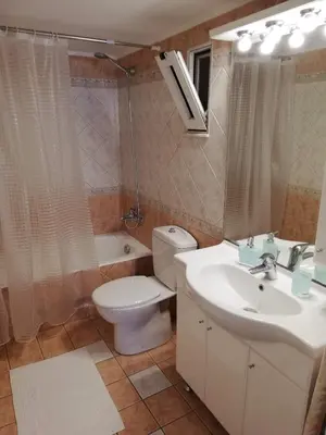 a bathroom with a toilet and a sink and a tub at Casa Dama in Rhodes Town