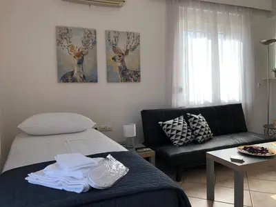 a living room with a bed and a couch at Casa Dama in Rhodes Town