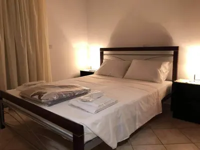 a bed with white sheets and towels on it at Casa Dama in Rhodes Town