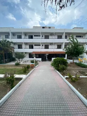 a building with a brick walkway in front of it at Ikaros Studios in Faliraki