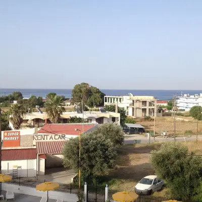 a view of a town with the ocean in the background at Ikaros Studios in Faliraki