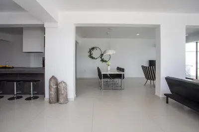 a white living room with a table and chairs at Habitat Inn Faliraki View Villa Rhodes in Kalithies