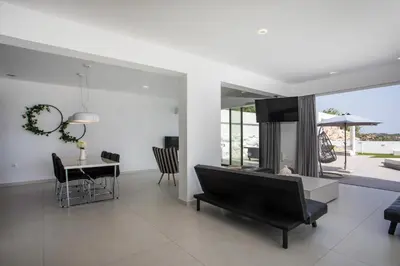 a living room with a table and a dining room at Habitat Inn Faliraki View Villa Rhodes in Kalithies