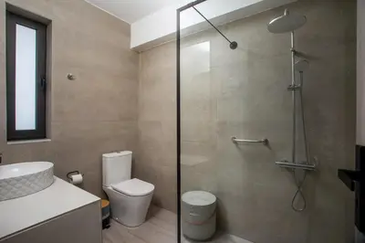 a bathroom with a shower with a toilet and a sink at Habitat Inn Faliraki View Villa Rhodes in Kalithies