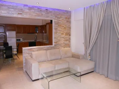 a living room with a couch and a glass table at Villa Olive Grove in Afantou