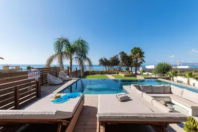 a swimming pool with a couch and a table and a swimming pool at Villa Del Nonno in Lardos