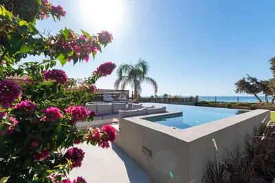 a villa with a swimming pool and flowers at Villa Del Nonno in Lardos