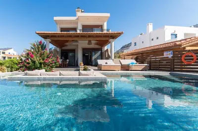 a swimming pool in front of a house at Villa Del Nonno in Lardos