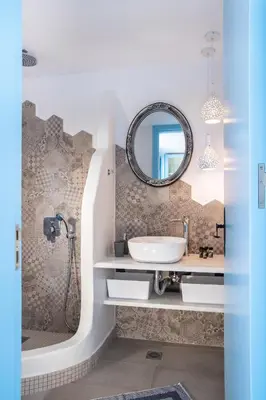 a bathroom with a sink and a mirror at Koskinou Traditional Houses in Koskinou