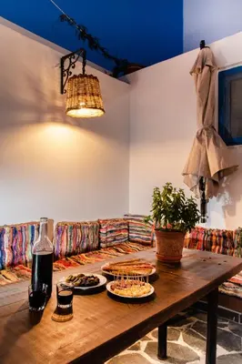 a wooden table with plates of food on a couch at Koskinou Traditional Houses in Koskinou