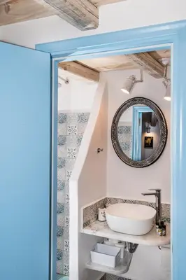 a bathroom with a sink and a mirror at Koskinou Traditional Houses in Koskinou