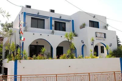 a white building with blue trim at Anthula Sun in Archangelos