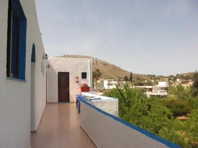 a balcony of a building with a view of a town at Anthula Sun in Archangelos