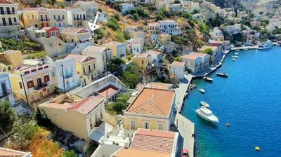 an aerial view of a town with boats in the water at Pitini Nikos house in Symi