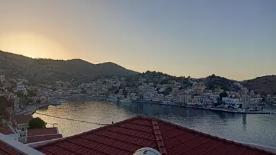 a view of a city with a river and buildings at Pitini Nikos house in Symi