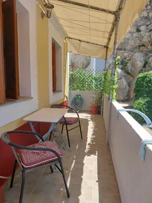 a patio with a table and chairs under a tent at Pitini Nikos house in Symi