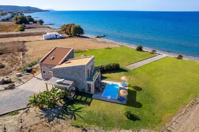 an aerial view of a house on the beach at Diagoras & Attalos Villas in Phanaes