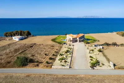 an aerial view of a house on a hill next to the ocean at Diagoras & Attalos Villas in Phanaes