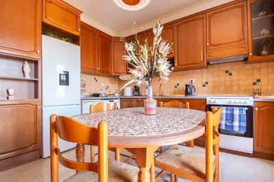 a kitchen with a table and chairs and a white refrigerator at Villa Elion in Symi