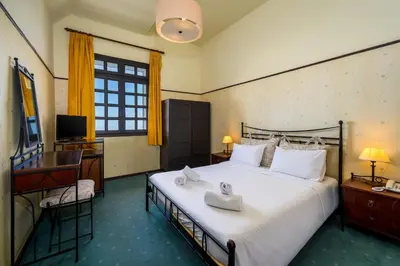 a bedroom with a bed and a desk and a television at Elafos Hotel in Sálakos