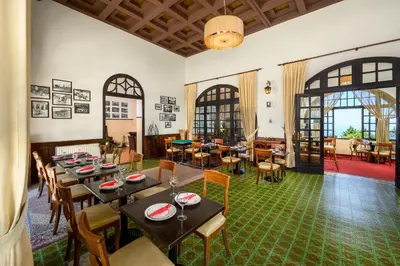 a restaurant with tables and chairs in a room at Elafos Hotel in Sálakos