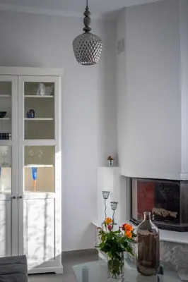 a living room with a table with a vase of flowers at Fontana Luxury Villa Salakos With Pool Near Beach in Sálakos