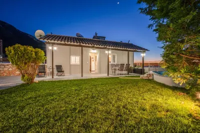 a small white house with a yard at Fontana Luxury Villa Salakos With Pool Near Beach in Sálakos