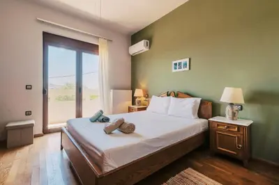 a bedroom with a bed with two towels on it at Hillwings Villa in Faliraki