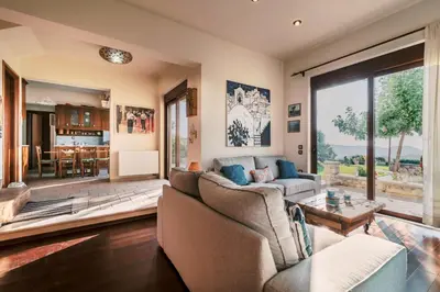 a living room with a couch and a table at Hillwings Villa in Faliraki