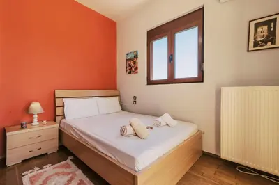 a bedroom with a bed with two towels on it at Hillwings Villa in Faliraki