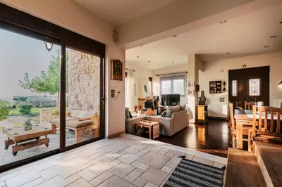 a living room with a large sliding glass door at Hillwings Villa in Faliraki