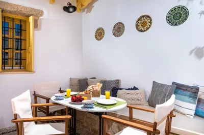 a dining room with a table and chairs at Villa il Vecchio Cortile in Rhodes Town
