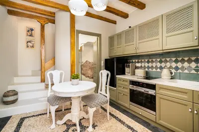 a kitchen with a white table and chairs at Villa il Vecchio Cortile in Rhodes Town