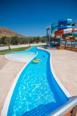 a pool at a water park with a water slide at Olive Garden Hotel in Lardos