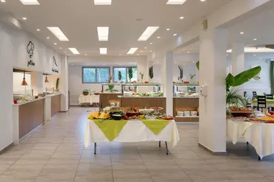 a cafeteria with a table with food on it at Olive Garden Hotel in Lardos